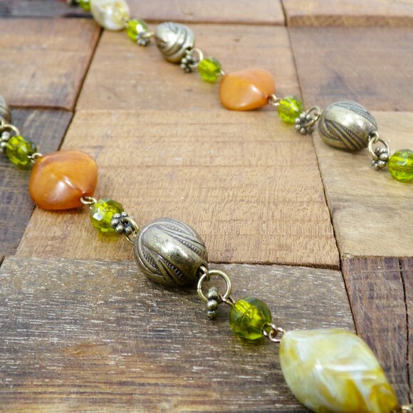 Multi color bead necklace with a mix of beige, green, and deep orange tones. - Picture 9 of 11